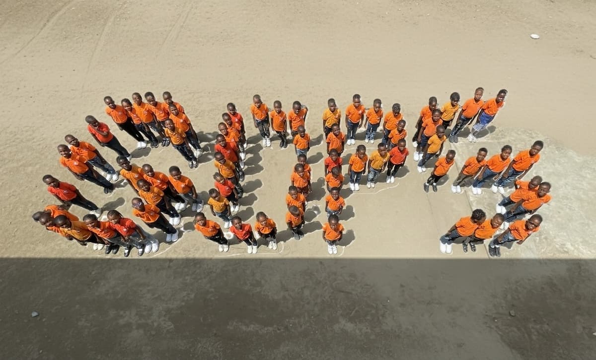 Students spelling GDPS on the field